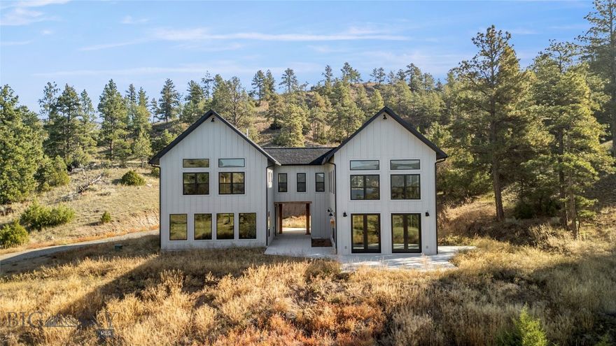Luxury, Efficiency, and Montana Living — All in One Stunning Home
Experience the perfect blend of luxury craftsmanship, modern efficiency, and the beauty of Montana living in this exceptional 3,200 sq. ft. retreat.
Step inside this zero entry home to discover white oak flooring, custom tile work, and soaring ceilings that create an open, airy feel throughout. Every detail has been thoughtfully designed, from solid Alderwood doors and trim to the expansive, open-concept floor plan that’s perfect for entertaining or multi-generational living.
This home boasts two full kitchens with granite countertops and Showplace cabinetry, along with two spacious living areas that provide flexibility and comfort for any lifestyle.
Wall-to-wall 8-foot Pella glass doors invite natural light to flood the interior while framing sweeping, Canyon Ferry Lake and territorial Big Sky Country views, seamlessly blending indoor and outdoor living.
Unwind in the spa-inspired bath, featuring a 6-foot jetted tub with an on-demand water heater, perfect for relaxing after a day of adventure.
Upstairs, a massive loft offers endless possibilities—create a game room, pool hall, or cozy lounge. A dedicated gym with its own bathroom provides even more versatility, easily converting into a theater, hobby room, or second entertainment space.
Built for year-round comfort, the home is equipped with dual-fuel, high-efficiency heat pumps and air conditioners, with two independent systems for ultimate climate control.
Additional highlights include:
A finished, zero-entry garage 
Rock wall insulation for superior energy efficiency
Room for horses and outbuildings, adding to its Montana charm
Located just minutes from multiple lakes and the Missouri River. Enjoy mountain biking, gravel riding, skiing, kayaking, paddle boarding, boating, sailing, hunting and fishing, 4115 Sawmill Gulch is more than a home — it’s a lifestyle.
Experience the perfect combination of luxury, practicality, and outdoor adventure in this one-of-a-kind Montana property.