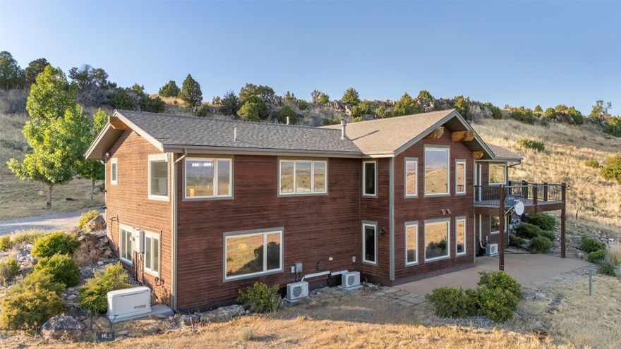 Welcome to your Montana dream home nestled on 20 acres in the scenic Gallatin River Ranch. This stunning 4-bedroom, 3.5-bath residence offers 4,110 sq ft of thoughtfully designed living space with radiant floor heating, air conditioning, and rich real wood hardwood floors throughout. Soak in panoramic views of the Gallatin Valley and Bridger Mountains from your expansive back deck. The main-level primary suite offers privacy and convenience, while a second primary suite in the walk-out basement is perfect for guests or multi-generational living. The remodeled lower level adds both comfort and versatility to the home. A striking stone gas fireplace anchors the spacious living room, ideal for cozy evenings. The chef’s kitchen features a large pantry and top-tier finishes, built to impress and built for function. Outside, you will find a serene water feature and space to make this property ideal for horses. A massive 2,000 sq ft insulated shop with a 14’ RV door provides space for all your equipment and hobbies. The attached 3-car heated garage adds even more convenience. Located in Gallatin River Ranch, residents enjoy private river access for fishing and floating, along with miles of trails. A private riverfront picnic area with fire pits and BBQs is perfect for summer gatherings. Whether you’re looking for peaceful solitude or room to entertain, this home delivers. Experience luxury, land, and lifestyle all in one place.