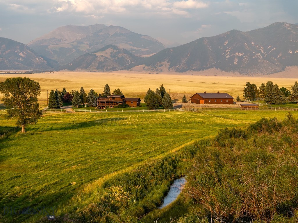 BIG House, Big Shop, Big Views and Water. Nestled in the picturesque Madison Valley, this property boasts stunning panoramic views of the surrounding mountains and vast open spaces. Conveniently located off just outside of town, the property provides easy access to Ennis and nearby recreational opportunities. The expansive 12+ acre lot offers ample space for various uses, whether residential, agricultural, or commercial. The well-maintained main residence spans over 4,000 sq ft and includes four comfortable bedrooms and three modern bathrooms. The home is designed to capture the essence of Montana living with spacious living areas featuring large windows that maximize natural light and breathtaking views. The modern kitchen is equipped with ample counter space, perfect for culinary enthusiasts. Additionally, the home features a game room for entertainment, a mudroom for convenient storage of outdoor gear, and a two-car garage offering secure parking and additional storage. Outdoor living spaces, including a two deck and patio, provide ideal settings for entertaining or simply enjoying the serene environment. The property providing plenty of room for outdoor activities, gardening, or even livestock. It has its own well and spring, plus water rights to Bear Creek, making it ideal for irrigation or creating a personal oasis. The land includes pastures, shop and a full-size barn, three horse stalls, full tack room complete with a bathroom and shower, catering perfectly to equestrian enthusiasts. The entire property is completely fenced, ensuring privacy and security for livestock and pets. The location also provides close proximity to popular recreational destinations like the Madison River, renowned for fly fishing, and expansive public lands ideal for hiking, hunting, and outdoor adventures. It is more than just a property; it's an opportunity to embrace the Montana lifestyle. With its prime location, extensive features, and breathtaking surroundings, it represents a unique chance to own a piece of the Madison Valley's natural beauty. If you are looking for an extensive home with all the bells and whistles, this is the home for you. Experience the ultimate Montana lifestyle your dream home with endless features awaits!