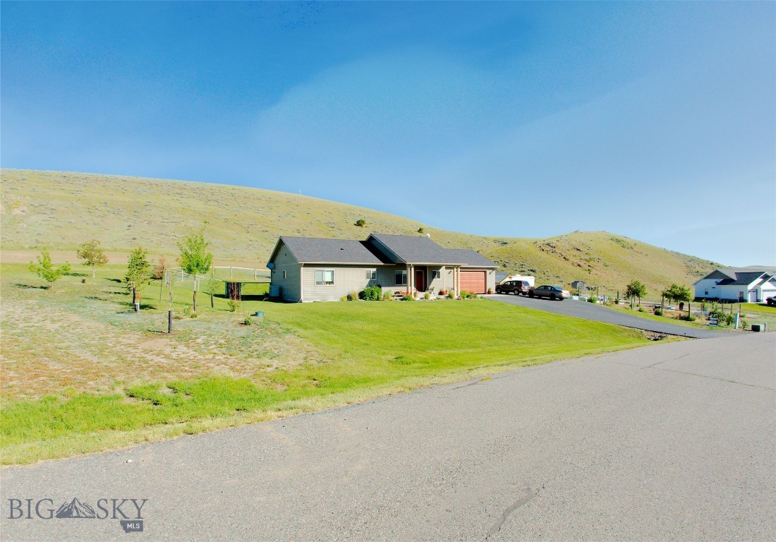 5 BEDROOM HOME ON 2 LOTS! Fabulous location in Village at Elk Ridge, Backing to the hills and park area with Panoramic views. Built in 2013 this home has so many amentities including; white oak flooring, underground sprinklers, central air conditioning, storage shed, family room downstairs, beautiful front porch to put your rocking chair, and additional lot for gardening or future development. This house is comfortable and a delightful place to call home.