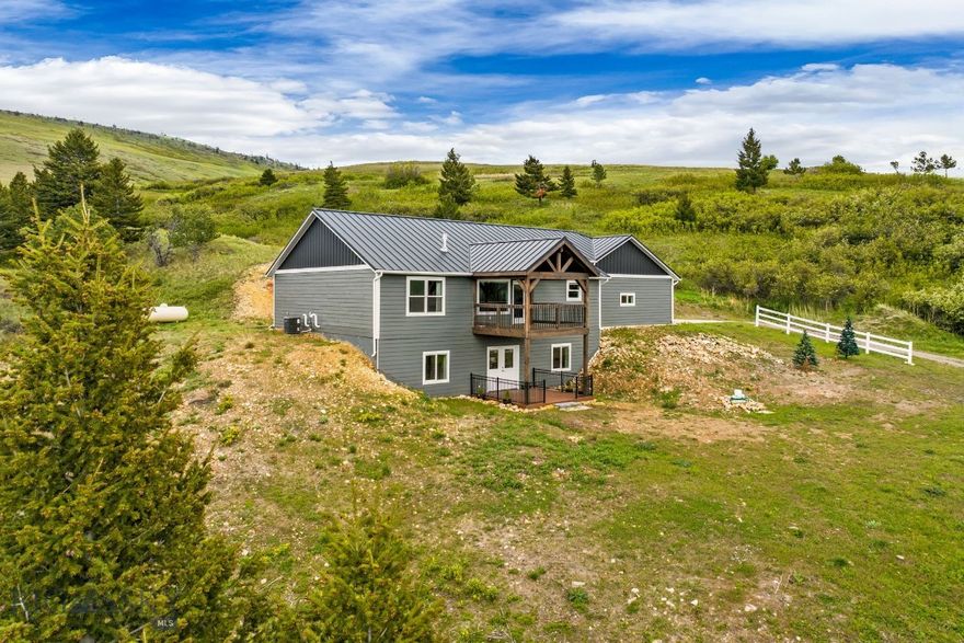 Temporary Price Reduction! Welcome to your Montana getaway — where rugged adventure meets modern comfort. 35 miles from Showdown Ski Resort and 1.4 miles to prime elk hunting near Sluice Boxes State Park, this property is a dream basecamp for hunting, hiking, skiing, and four-season recreation. Built to last, the basement boasts R-50 insulation, the exterior walls and garage insulated with R-40 foam, and the attic insulated with R-50 foam, ensuring superior energy efficiency. The maintenance-free Smart Siding, seamless metal roof, and full metal gutter system mean more time outside and less time on upkeep. After a day in the mountains, the heated garage is complete with drain and hot/cold water, making gear cleanup or game processing effortless. Inside, the kitchen shines with marble counters and high-end quiet-close cabinetry, pairing durability with luxury. A living room fireplace casts a warm glow to complement the mountain sunsets visible through the large living room windows. The finished walkout basement leads to a covered patio, a perfect spot for a hot tub, sauna, or seating area. At 50 Sluice Box Road, you’ll wake to vast mountain views and endless skies — the true essence of Big Sky Country. Whether you’re seeking a private retreat, a recreation hub, or a legacy property, 50 Sluice Box Road delivers unmatched adventure, quality, and comfort in one package.