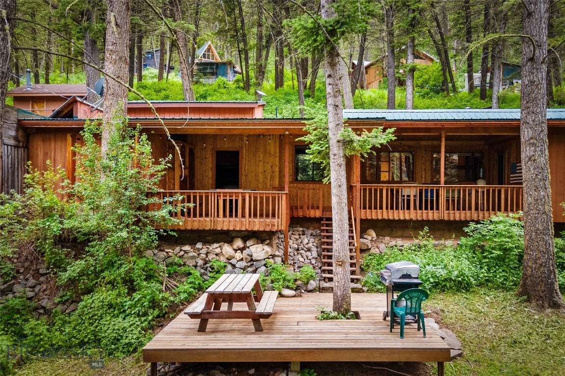 If you're looking for a quintessential Montana adventure, then THIS is YOUR property. Tucked into a piney hillside, across the road from the Gallatin River and just beyond the shadow of Storm Castle Peak, this location is spectacular: Big Sky is 25 minutes up the canyon, and Bozeman is 35 minutes to the north. Plus the Gallatin National Forest pretty much surrounds the place with its endless miles of hiking trails, mountain lakes to explore, fishing, rafting, and more. Here's the basic info on the buildings: MAIN HOME: 3 bedrooms, 2 baths, kitchen, dining area, cozy living room with wood burning stove, and lots of deck and patio space. CABIN: 1 bed, 1 bath, kitchen, equally cozy living room with wood stove, loft for extra sleeping space, and wrap around deck. BUNK HOUSE: 2 bunk beds, a fridge, wood stove, and small deck. What it lacks in water (there's none, so no bathroom) it makes up for it with historic charm. DETACHED GARAGE: 2 doors, one tall RV door, plenty of storage space and an unfinished loft above. This would make the perfect gathering place for family & friends, or a great vacation rental. There's lots to unpack and the description & photos can only do so much, so call for your private tour. You'll fall in love once you see it in person. This property is also listed in the Multi-family category as MLS#403230