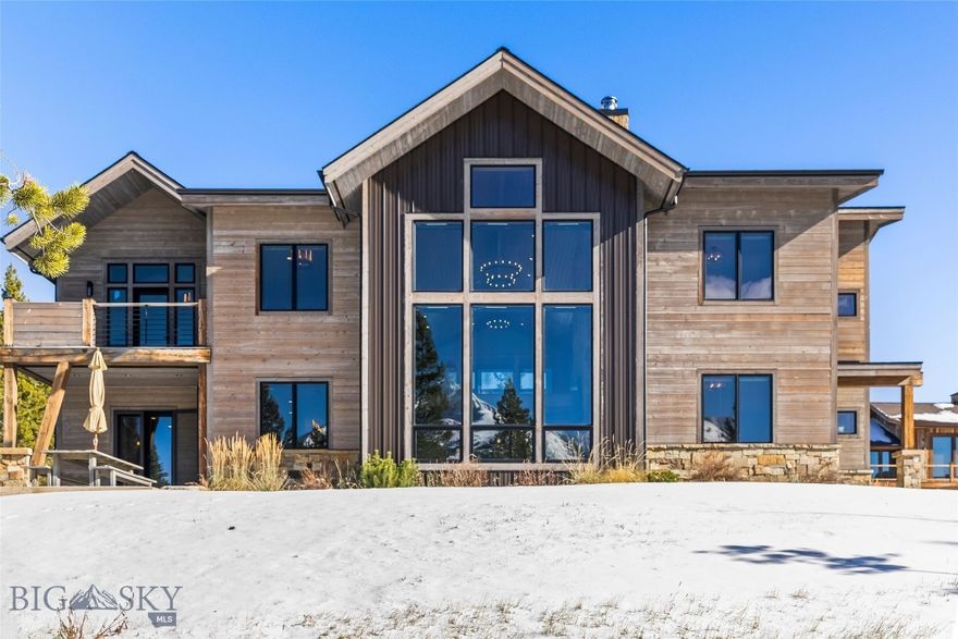 This is truly a skier’s home—wake up, scope your line with your morning coffee, and ski directly out your door to Big Sky Resort. Thoughtfully designed for mountain living, the home’s modern industrial style is softened by natural wood, stone, and abundant sunlight that fills every space. The great room showcases floor-to-ceiling windows framing Lone Peak, while the chef’s kitchen is designed for gathering—spacious, functional, and perfect for entertaining. Separate gas and electric ovens, a large granite island, a walk-in pantry, and a separate wine room bring both ease and character to the heart of the home.

They say there are no friends on a powder day—but this house proves otherwise. After skiing home, there are ideal places to share stories—from the classic wood-burning stone fireplace to the family-room loft, or soaking in the hot tub—before retiring to private spaces. Each of the five bedrooms in the main home features an ensuite bath and beautiful mountain views, capturing Lone Peak, Fan Mountain, and Andesite from different vantage points. The separate one-bedroom guest apartment offers full independence with its own kitchen, laundry, and a stair railing crafted from the original Big Sky tram—a distinctive nod to the mountain’s heritage.

Offered furnished, this Cascade neighborhood retreat blends thoughtful design, craftsmanship, and comfort for effortless living in Big Sky.
