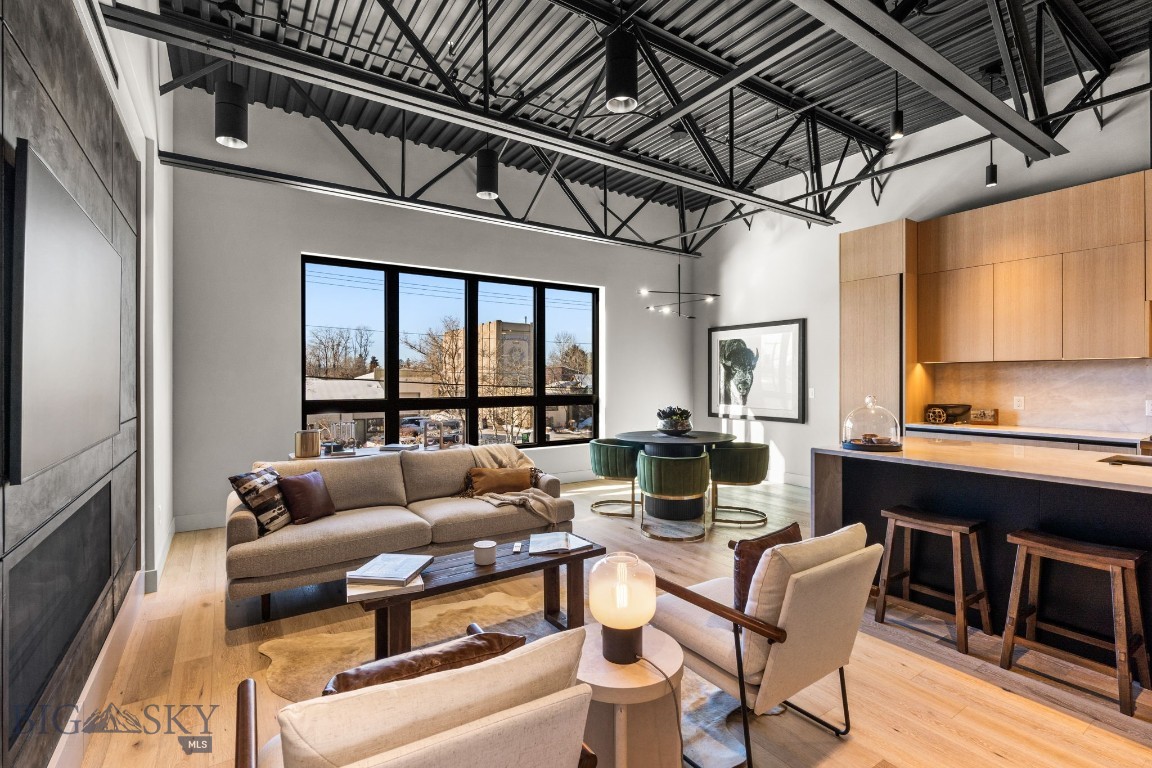 Indulge in modern luxury with a touch of Bozeman charm at Residence 202. This impeccably designed 2-bedroom, 2-bathroom condo boasts over 1600 square feet of living space and an additional flex space off the main living area. Enjoy a private deck off the primary bedroom totaling over 400 square feet, giving you plenty of urban outdoor living space. 
With 7 ft windows and soaring 12-foot ceilings, Residence 202 offers abundant natural light throughout, further enhancing the sense of the open living space, while maintaining an industrial-loft feel. Sleek Poliform cabinetry and high-end appliances, accented with finishes such as a stunning gas fireplace create a luxurious ambiance throughout the home. This exceptional residence caters to both savvy investors and those seeking a luxurious mountain-town retreat. With only 12 residences in total at Wildlands, you are sure to immerse yourself in an exclusive downtown location ensuring unparalleled privacy.