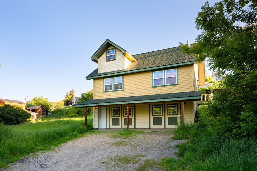 105 W Cover Street | Virginia City, Montana

Tucked away on a quiet, tree-lined street just one block from the historic boardwalk, 105 W Cover Street offers all the charm and character of a Montana mountain town with the comfort and craftsmanship of a thoughtfully designed home—plus a developable adjacent lot to the west, offering expansion potential rarely found in Virginia City.

Built in 2006 to reflect the historic aesthetic of the community, this 1-bedroom, 1-bath home features an open-concept kitchen and great room with vaulted ceilings, exposed beams, and a cozy wood-burning Lopi stove. A second-story loft serves as a bright and airy bedroom retreat, while the walkout basement includes two garage bays with large swing-out doors, insulation, finished drywall, and plumbing already in place for an additional bathroom.

The basement offers flexibility for future expansion—a bunkroom, guest suite, or gear room—and the right-hand garage is already separated by a wall and lockable door, perfect for storing personal belongings if you choose to rent the home seasonally. As an added bonus, the back portion of the garage is built into the hillside with substantial concrete work, making it naturally cool and well-insulated year-round—a perfect opportunity for cold food storage, wine, or root cellar use.

Step outside and enjoy the peaceful sound of Daylight Creek babbling across the street, and the calm, shady vibe of Cover Street—just a stone’s throw from the action, but worlds away in feel. The included neighboring lot offers room to garden, build a guest cabin, or simply enjoy as open space.

Whether you're seeking a seasonal retreat or a full-time residence, this location offers four-season adventure with public land access for hiking, biking, off-roading, and cross-country skiing. Virginia City buzzes with life in the summer months, filled with history, local shops, and fine dining, and settles into a welcoming quiet during the winter.

Located just over an hour from Bozeman and Big Sky, this is a rare opportunity to own a move-in-ready home with room to grow in one of Montana’s most storied and scenic mountain communities.