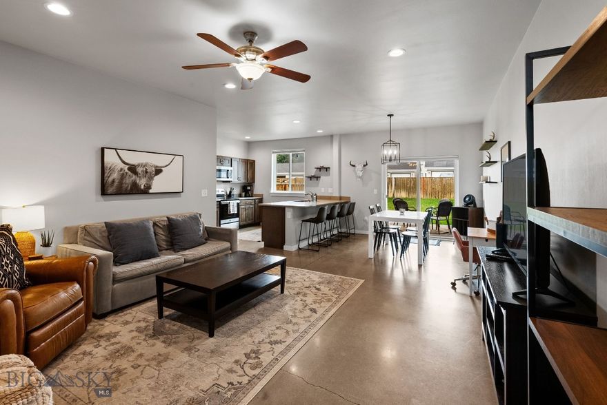 Just bring your suitcase and move into this fully furnished, turn-key property—a beautifully maintained 2-bedroom, 2.5-bath townhouse offering 1,321± sq. ft. of thoughtfully designed, low-maintenance living in Bozeman’s highly desirable Valley Meadows subdivision.

Built in 2018, this charming two-story home features a bright, open floor plan that maximizes natural light and flow. The main level showcases stunning radiant concrete floors, creating both warmth and modern appeal. The spacious living area connects seamlessly to the dining space and a well-appointed kitchen with stainless steel appliances, sleek quartz countertops, and abundant cabinetry for all your storage needs.

Upstairs, the primary suite offers a private en suite bathroom and generous closet space, creating a true retreat. A second bedroom, perfect for guests, family, or a home office, has easy access to a full hall bath.

Enjoy indoor-outdoor living with a covered patio leading to a fully fenced backyard—ideal for pets, gardening, or year-round entertaining. A single-car attached garage with extra storage adds convenience.

Located in a vibrant neighborhood, you’re just steps from a community park with open green spaces, walking paths, and playgrounds. Additional parks, scenic trails, top-rated schools, shopping, and dining are all within quick reach.

Offered fully furnished, this townhouse is truly move-in ready—perfect as a primary residence, vacation home, or investment property. With its modern style, functional spaces, and unbeatable location, it’s an incredible opportunity at an attainable price point.