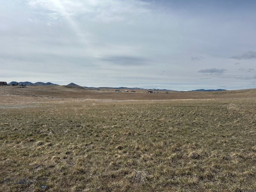 This large lot has ample room to build your dream home or spec house, and it backs to an open field for the feeling of large open spaces.  The access to the lot is paved roads that are just minutes from Three Forks.  This neighborhood contains parks, basketball courts, and mountain views in all directions.  With quick access to Three Forks, I90 for a quick commute to Bozeman, and only minutes from the Copper City bike trails, it is the perfect location.  This is a rare opportunity to own a lot in this neighborhood that backs to large open fields so don't wait to see it.