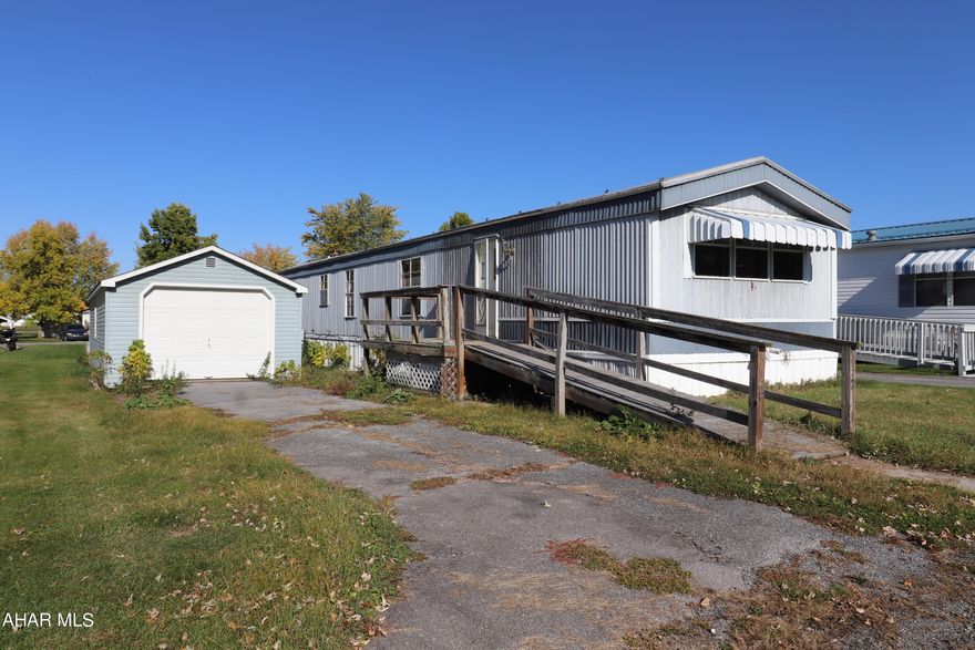 Your two-bedroom home at 532 Camerer Lane with its new carpet, open living room, spacious kitchen, and one bay garage awaits your special touches. In the heart of rural Blair County, Martinsburg offers you the opportunity to relax at a nearby cafe, enjoy baked goods, ice cream, or a delicious meal at the local restaurants, browse in downtown shops, spot airplanes come and go from the Altoona-Blair County Airport, or find recreation opportunities at the Martinsburg Memorial Park. 

All buyers must complete an application to rent the MR7 Spring Manor Community lot at gomobilerealty.com or call 717-519-5200. Lot fee is $405 per month and includes trash removal.