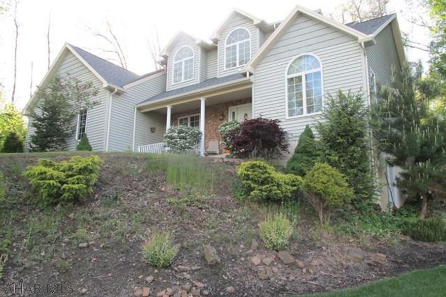 Enjoy the spectacular view from this tastefully decorated 2 story. Snuggled into the hillside, private and peaceful setting. Spacious rooms with 10 ft. ceilings and crown molding in master suite, living room with cathedral ceiling & gas fireplace, dining room open concept with pillars, white cabinets in kitchen with granite counter tops, 1st floor master suite and master bath with whirlpool tub and separate shower, 1st floor laundry, enclosed (screened) rear porch and deck. 2 Car garage, full basement, unfinished with rough-in for bath. Water treatment system owned. Radon mitigation system. Ceiling fans in all bedrooms and living room.