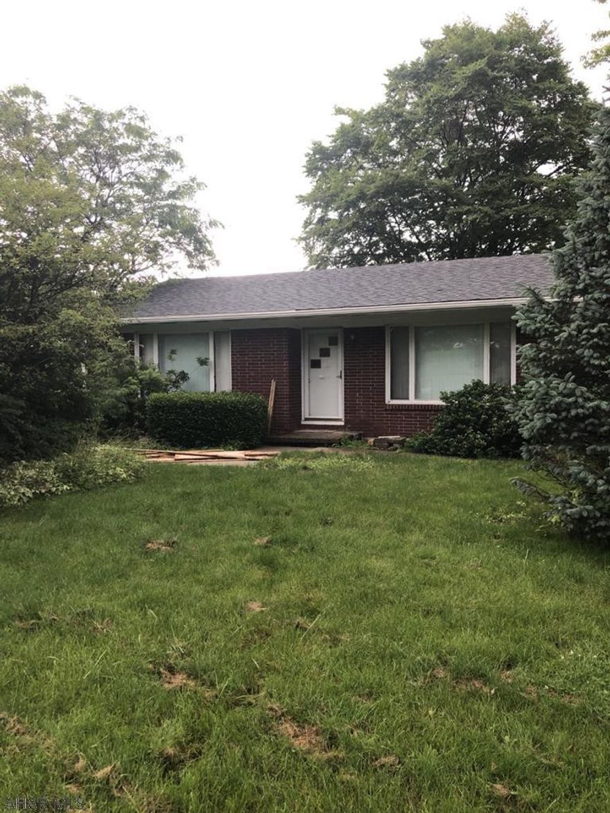 Duplex, office building and 6 car garage. Red brick duplex, 1 side occupied- 1 side vac. Gray vinyl sided office with 2 car integral garage and separate 6 car garage. Property has its own septic