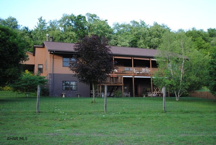 This is a truly custom home!!! It is a ranch style home situated on 10 private acres with an attached mother-in-law suite that is 100% handicap accessible. This home has includes a 60'x30' horse barn with 5 stalls with electric to each stall and 3+/- acres of fenced pasture.  Another feature is a 30'x60' pond in the front yard. The main side of the home has an attached 2-car carport. This home also has a generator and separate generator panel box so when you loose power heating, water, and bathrooms all work.