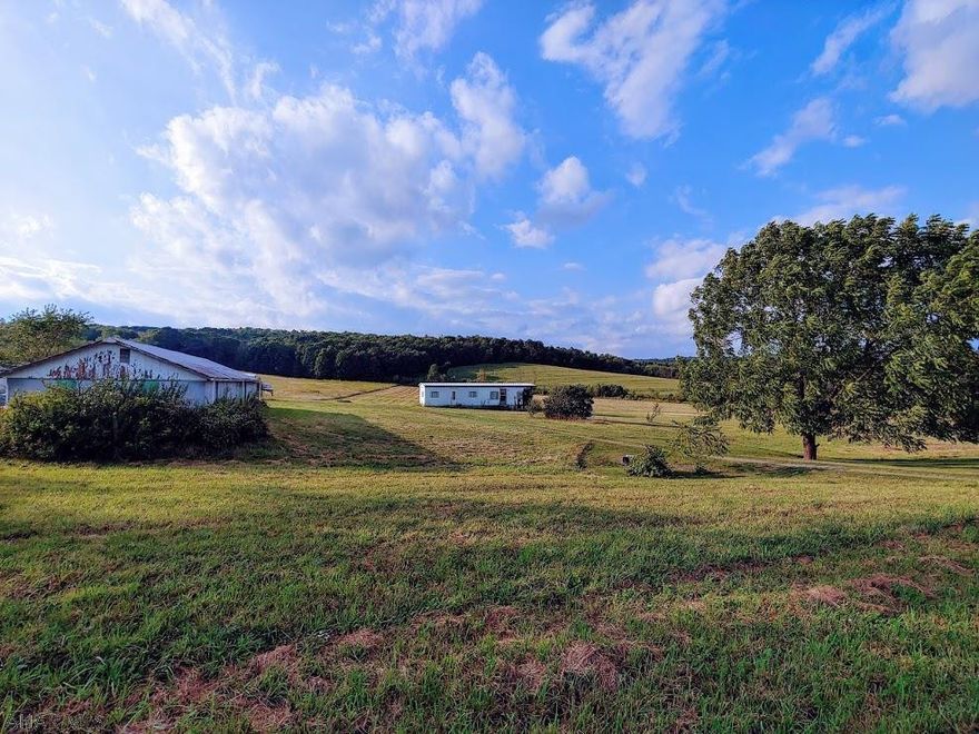 What an opportunity for someone looking for open space! 14+ acres of rolling ground in Bedford County. Single-wide trailer could be used as a hunting camp, full time living, or even serve as housing while you build your dream home! City sewer is run to lot line for future connection by the new owner. No Zoning in this area! Large shed is included to house any toys, or even animals, you may want to bring along. Shared Right of Way to access the property...but then it's open ground! So come out and let your imagination play a bit while you picture what can be become on this piece of land located between Lovely and Pleasantville.