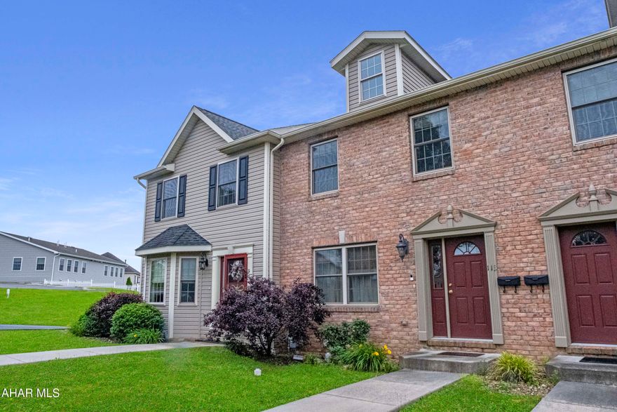 Beautiful brick-front townhouse located in the sought-after Holiday Hills neighborhood in Hollidaysburg Borough and School District. This move-in ready home offers maintenance-free living and stunning views from the rear deck, complete with a retractable awning for outdoor comfort. Inside, you'll find a well-equipped kitchen with ceramic tile floors, a center island with seating, and a bright breakfast area. The open-concept living and dining room is accented by elegant Tuscan columns, creating a warm and inviting space. The spacious owner's suite features a walk-in closet and a private full bath. The finished lower level provides a large family room, perfect for additional living or entertaining space. Additional highlights include a one-car integral garage with a newly installed EV charger. Built in 2011, the home offers approximately 1,600 square feet above grade and 400 finished square feet below, with 2 full baths and 1 half bath. No HOA fees—just easy, comfortable living in a prime location. Check out our Matterport 3D virtual tour and schedule a showing today.