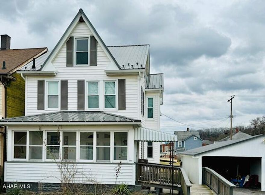 You will not want to miss seeing this charming two story home situated on a double lot! The front entrance you walk into a large coat and shoe room for your storage needs. Enter through the front door to a lovely stair case. Go to the right and you will enter into a cozy living room that opens up to a large size dinning room. The kitchen has updated cabinets and lots of storage space. Included is the refrigerator, stove and built in microwave, fresh paint and updated counter tops. Off of the kitchen you will find a nice size full bath, also on the first floor has a nice size laundry room for your convivence. Up the stairs to the second floor you will find three nice size bedrooms and a large half bath. The third floor could be finished for additional living space. Outside entrance from laundry room leads out to a small covered porch facing the large yard. For added storage you will find a large shed in the back yard. The property also has a detached two car garage currently being used as a carport, would require two garage doors. This property also features newer metal roof and gutters, newer furnace, newer windows and newer flooring throughout. An added plus is new central air. Come take a look at this house and see how the extra lot would be great for outdoor entertainment.