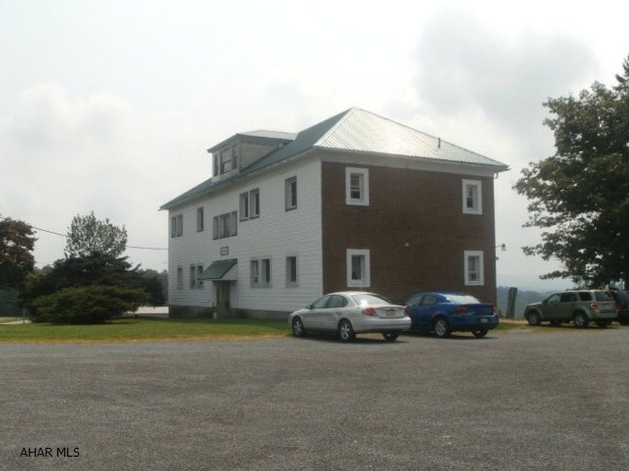 Brick 6 unit that was converted from a school around 1976. Most tenants have been here over 10 years. Well and septic.