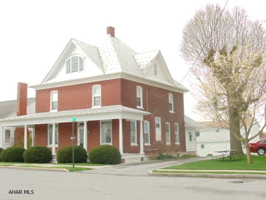 Great 2 1/2-story brick home with wraparound porch, natural woodwork, hardwood floors, 2 sets of pocket doors, spacious eat-in kitchen, formal dining room, 1st-floor bath, bonus entry room, electric breakers, & detached garage.  #J-063