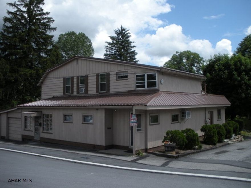Former insurance office with two rental units.  Office space can be converted to 1 bedroom apartment with some modifications--long term tenants.  Owner pays heat, water/sewer.  Tenants pay electric.  Good visibility from Logan Blvd.,  Newer furnace, hot water heater and metal roof.  100 amp breaker services.