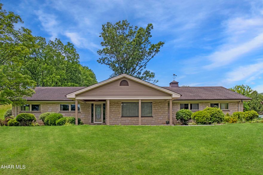 This classic custom-built ranch home offers the perfect blend of timeless character and modern convenience. With 4 bedrooms and 4 bathrooms, this spacious home is wrapped in beautiful cut stone, giving it a distinctive and elegant exterior. Inside, you'll find all-new flooring, fresh paint, and high-end windows that flood the living spaces with natural light.

The well-designed layout provides generous room sizes, abundant storage, and updated bathrooms, all enhanced by central air for year-round comfort. A finished basement with a chairlift offers added flexibility for living space or accessibility needs. The oversized garage is ideal for vehicles, hobbies, or extra storage.

Set on a peaceful 1.27-acre lot, this property features a charming front porch where you can unwind in the evenings and enjoy watching the local wildlife. This is a rare opportunity to own a truly custom home that combines space, quality, and serene surroundings.