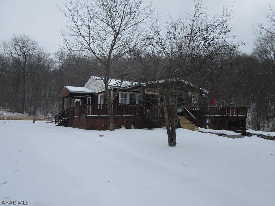 One story home on 1.4 acres being sold to settle estate. Nice modern kitchen, living room with fireplace, dining area, large family room. 2nd bedroom is used as a laundry room but is easily converted back. Wrap around covered deck.  Shared driveway entrance. Small pond. Great home for the $$.