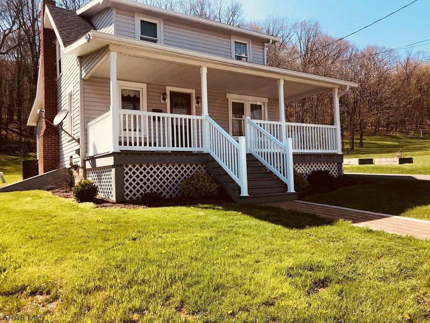 Looking for a quaint and cozy beautifully renovated 3 bedroom, 2 bath home with tremendous curb appeal, then look no further.  This home includes updated flooring, windows & siding, heat pump, central air, roof, appliances, covered porch, garage, bathrooms and kitchen w/ breakfast nook.  Features like a main floor laundry, bathroom and huge kitchen island and walk out to a tree lined stone terrace are just some of the uniquely designed attributes that make this home so special.  The maintenance free covered front porch and garage completes this meticulously maintained home.