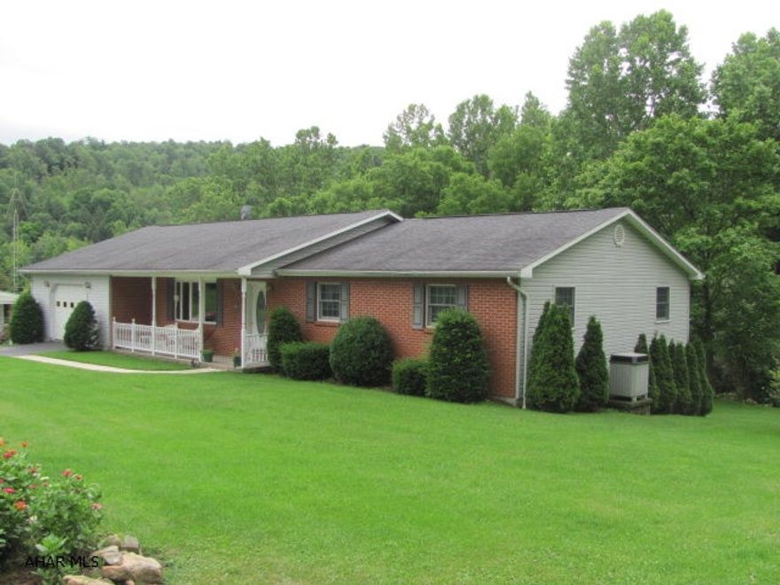 This beautiful home sets on the edge of town and offers a private country style setting. This home has been very well maintained and is move in ready. This large Ranch home offers a large open kitchen and dining room area, includes a large living room and has three bedrooms with two full baths and an additional 3/4 bath in the laundry room. The attached oversize garage is 16 x 28. Full unfinished basement could be designed to meet your family needs and recreation. The home is surrounded by vacant lots used for gardening, flowers and fruit trees and extends into a wooded area.