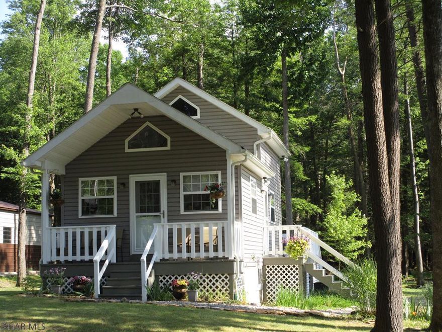 Almost an acre of immaculately kept yard and woods with a matching cabin included.  Many extra touches show the love put into this home.  Some are practical, like a restroom on every floor and many storage areas. Others are for the eyes, including garden areas and the deer window.  The loft bedroom comes with a great view of the woods out back, drawers under the bed on both sides, and a half bath.  Two recliners and a couch offer plenty of seating in the living room.  Kitchen has all newer appliances.  Bath with large shower on the main floor.  Send the overflow to the basement family room sofa sleeper.  This area could easily become another bedroom with a 3/4 bath handy.  Heat pump installed in 2014, furnace 2019..  Oversize shed has electricity.  Waiting for your call!
