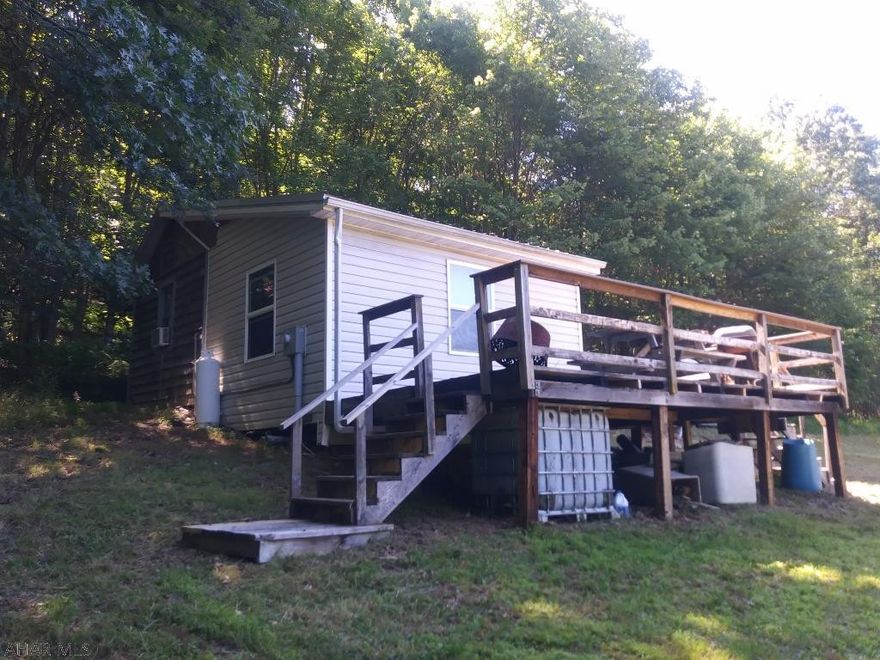 Partially wooded, partially cleared 4.9-acre lot close to state game lands. This property has underground electric and a small cabin consisting of a kitchen/living room area and a separate bunk area which can sleep 6-8 people. Amazing views from the deck and a nice place to enjoy nature. Only a few miles from the Maryland border and Rocky Gap.
