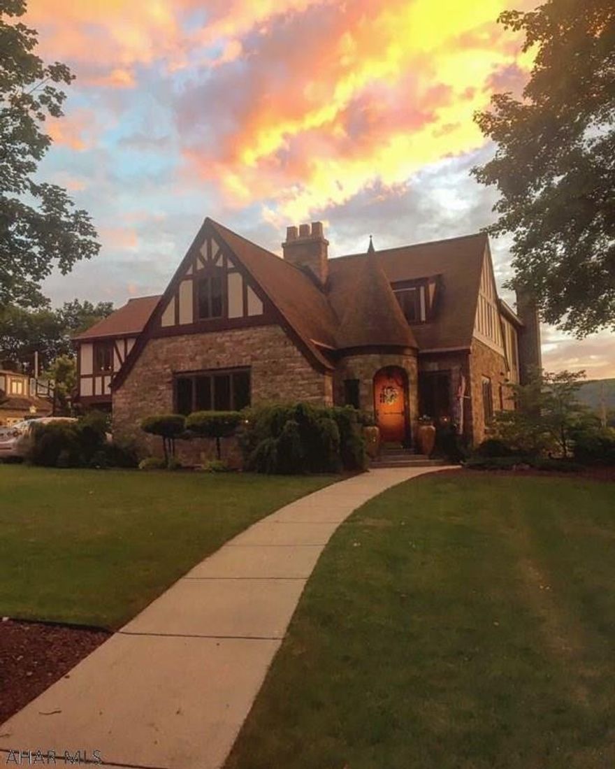 This Prestigious English Tudor Mansion and Carriage house offers quality upgraded features that are sure to impress.  Gated property with castle style turret entry, stone Porte-cochere, arched doorways, 4 fireplaces, cherry custom cabinets, and more. This property includes a 6-bedroom, 5-bath main home w/ an additional 4-bedroom, 2-bath carriage house, 3-bay garage w/ finished second floor exercise room.  Take a walk to the Historic town of Bedford or sit on the back patio oasis while enjoying courtyard and salt water pool.  Complete with its own pool house and stone pizza oven.  Entertaining at its finest!