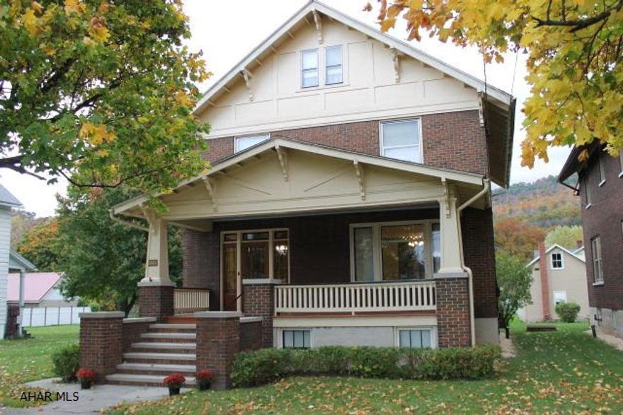 Charm and character fill this beautiful brick home, from the gorgeous original woodwork and floors to the lead and stained glass windows. The large foyer leads to the living room with built-in and pocket doors to a dining room with conferred ceiling. A swinging door leads to the updated kitchen with large pantry. A mudroom with built-in benches and sink off the side porch complete the 1st floor. Open staircase to 2nd floor with 4 bedrooms and full bath. Master bedroom has a sitting porch. Attic has 2 large rooms for storage. Large flat yard with a garage and workshop.