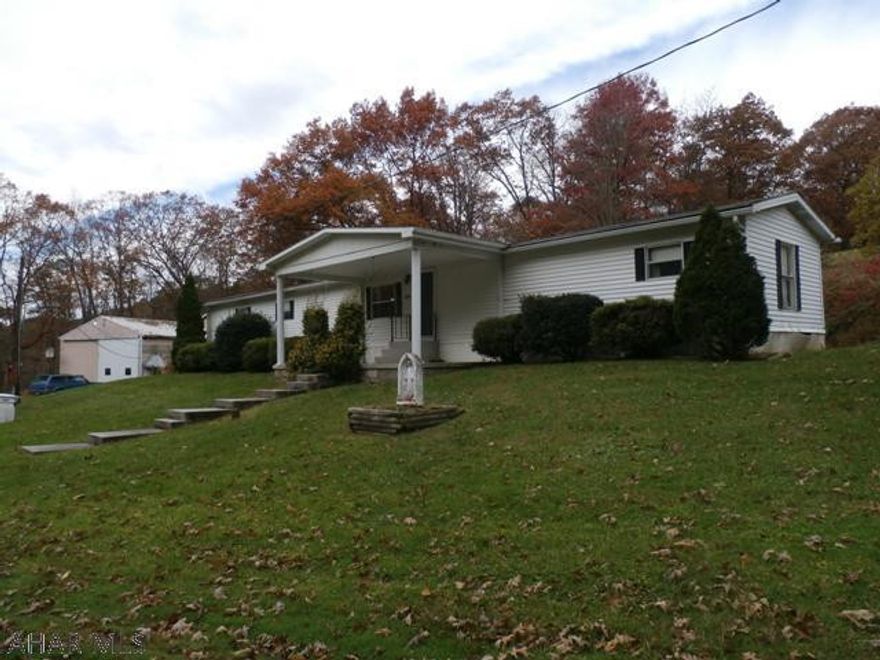 Singlewide w/addition & lg. inviting front porch on 3+ acres! Mud room, galley kitchen & spacious great room w/ wood burner. Lg. Master bedroom w/ walk-in closet & full bath w/ garden tub. Two more bedrooms and a full bath. Everything conveniently located on one level. Carport & truck RV garage. This oversized garage is a great place to work on cars or store your RV. -has a furnace & 1/2 bath. The 14 x 40 deck allows you to grill, entertain, relax & enjoy.