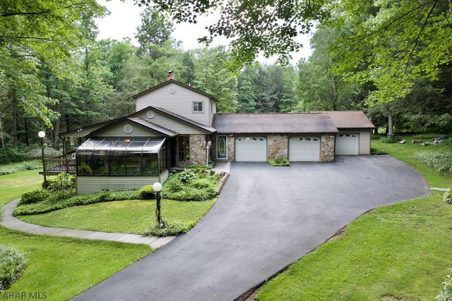 Two story home on an approx 1.2 acre private lot.  The home is surrounded by trees and features 4 bedrooms, 2 full baths, 2 half baths, and a 3 car garage.  The flooring has been replaced throughout the entire house within the last year.  A mini-split unit has been installed in the last year as well.  There is a wood burner in the living room and a large sunroom right off the living room.  The property is located close to town, convenient for shopping and entertainment.