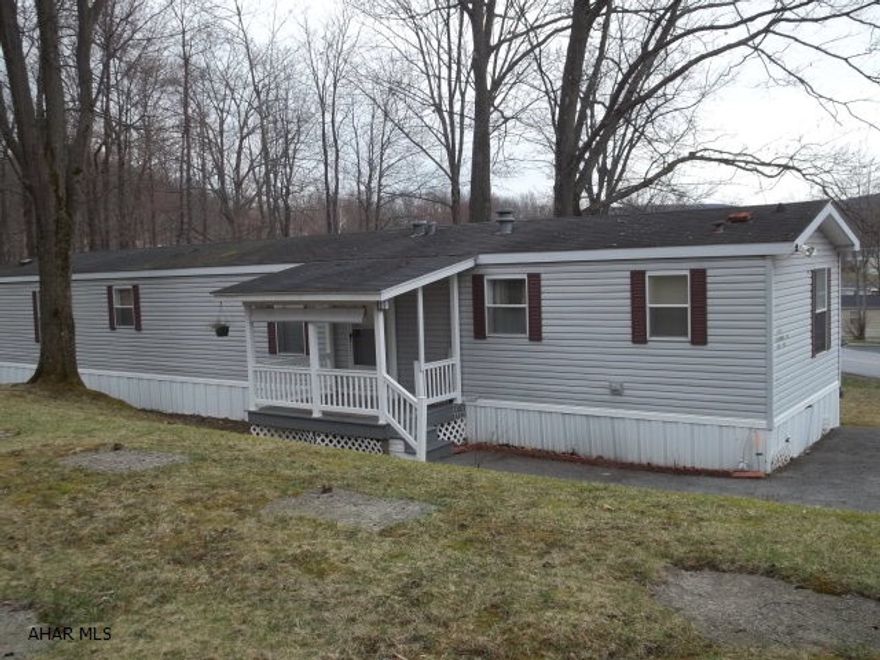 Such a sweet location!  Nice large lot with woods in the rear.  Quiet porch to enjoy the view. Roomy with a nice open floor plan.Lot Rent is $328 per month - includes sewer and trash.THIS MOVE-IN READY SINGLE WIDE COULD EASILY BE MOVED TO ANOTHER LOCATION.