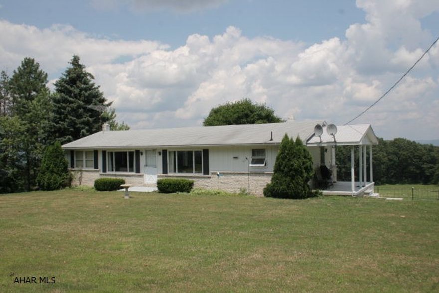 Well maintained ranch style home of modular construction with a full finished walkout basement. Two bedrooms (two smaller bedrooms were converted into a large master bedroom). One full bath and one 1/2 bath; laundry area; Basement is finished with a family area and a separate kitchen/canning area. Main level is an open plan with a large kitchen/dining area. Large rear deck with a commanding view in a great rural setting.