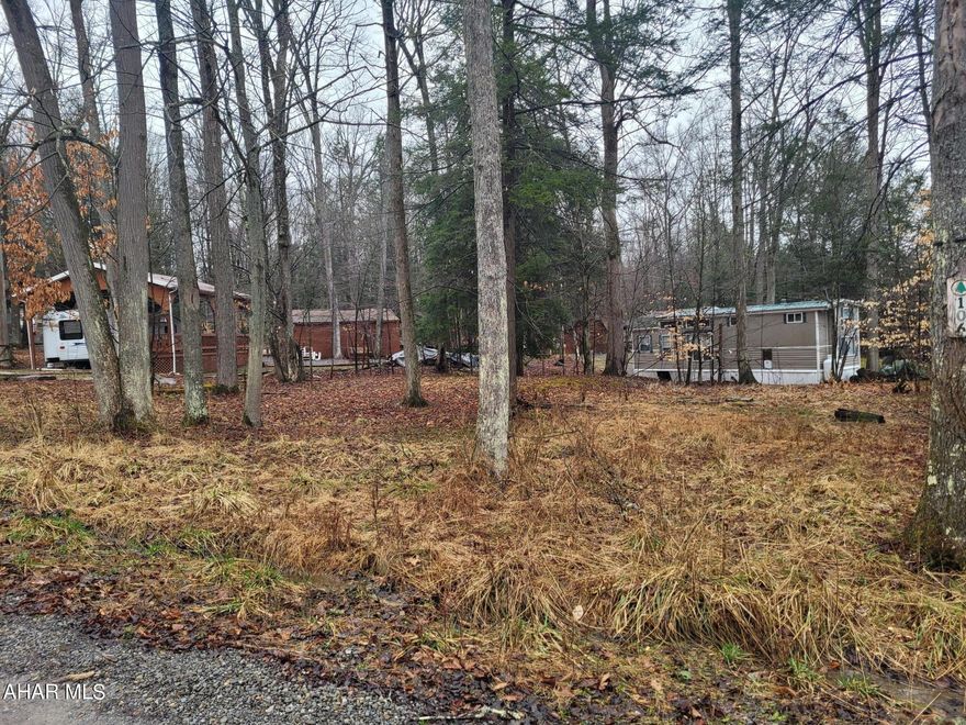 Double wooded campsite with utilities ready for your camper.  Don't wait to make memories with your family.