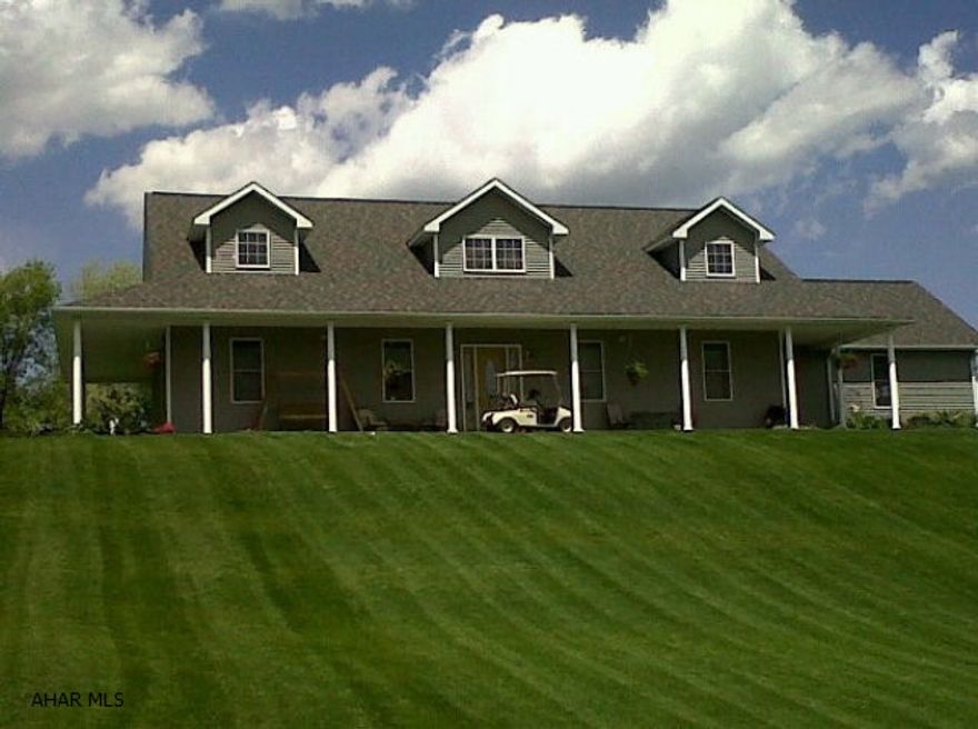 Tour this home in 3D on brokerage website! Enjoy the peace and quiet of country living just minutes from downtown Hollidaysburg. This home features 6 bedrooms & 4 full baths. The stunning master suite has a walk-in shower & a soaking tub with a double-sided gas fireplace that you can enjoy in the bathroom & bedroom. Downstairs is entertainment central with a theater room, bar with custom lighting, game room and gym. The expansive kitchen opens out into the dining room where a large window seat offers additional seating and storage. A stone fireplace in the living room is adorned with a hand cut barn tress as the mantle piece. Outside, relax on the large deck or spend evenings stargazing from the hot tub. In the backyard - a pond, waterfall, rustic fire pit, trout stream & walking trails!