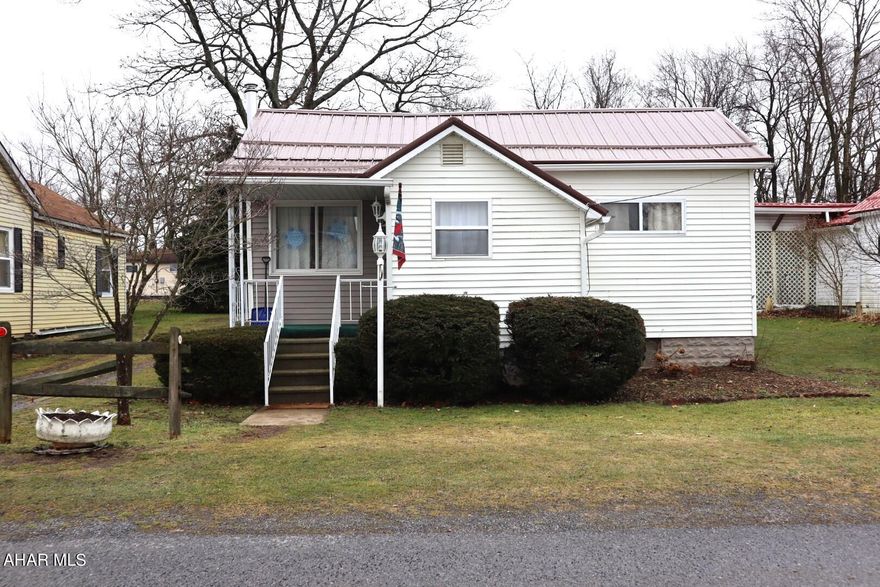 This move-in ready and well-maintained home includes numerous updates! Open floor plan from living room to dining area opens to a large back patio.  Enhancements to the kitchen include newer laminate flooring, newer microwave,  newer dishwasher, under-cabinet hard-wired lighting, and extra new cabinetry. The Bathroom has been updated with new walls and flooring. Major additions include a new Metal Roof (2023),  Wood/Coal Burner with Chimney (2023), Hot Water Tank (2022) Backyard Fence (2021), Oil Furnace (2020), and Radon System (2020).  The Backyard is level and partially fenced-in with gardening areas and a small garden pond. Off-street parking is available in the driveway to the left of the home. As an extra feature, the home is also wired for the availability of a generator. This home is within walking distance to center town. Come and take a tour!