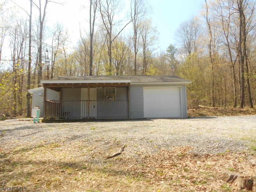 Close to the Omni Bedford Springs Resort. Privacy with a small little cabin. 2 bedrooms, 1 full bath, electric baseboard heat. Covered deck. City water and sewer. Seller had a survey and it has 23.26 acres. Many fun uses for this rare find. Full-time living, hunting or vacation home. Everything left at cabin is included.