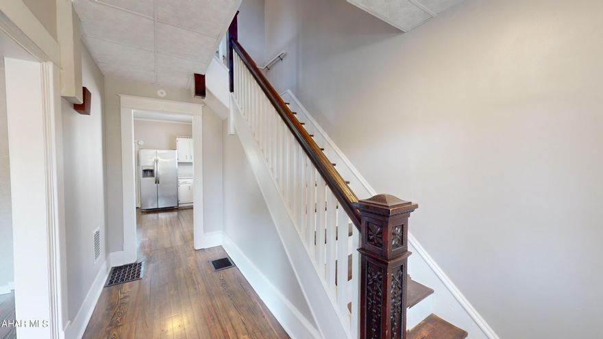 Welcome home! This home is move in ready and full of charm! Wood floors throughout have been refinished. The living room features a large window for plenty of natural light. The living room flows beautifully right into the dining area. The kitchen is bright and airy featuring white counter tops as well as white cabinets. There is an enclosed porch off of the kitchen that doubles as a laundry room. Upstairs you will find a newly updated full bathroom and 3 additional bedrooms. The attic is finished and complete with heat and a closet, perfect for an office or 4th bedroom. New roof was installed in June of 2024! Fenced in back yard and 1.5 car garage. Dont miss out!