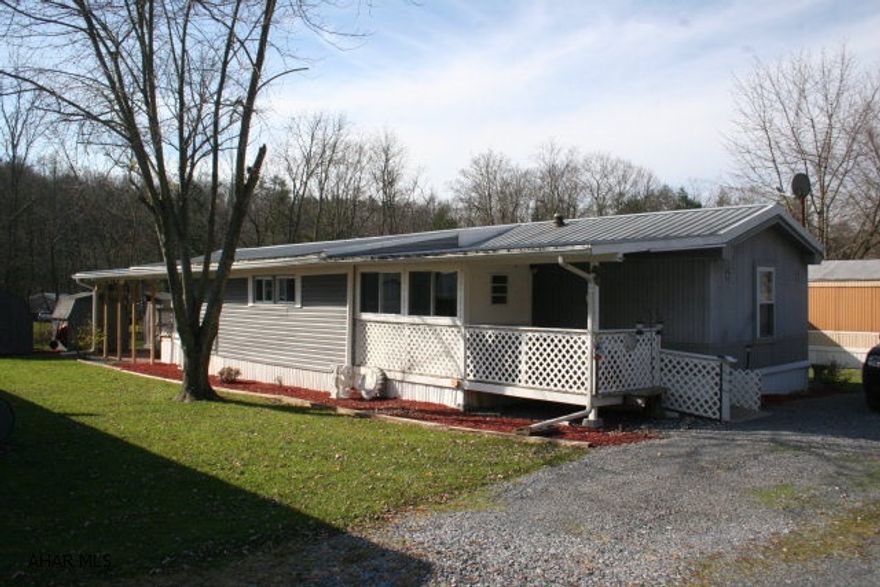 This is a beautifully maintained and upgraded 14x80 mobile home with a quality integrated 10' x 36' addition; very spacious interior. A well designed ramped entrance, interior construction and design makes this property handicapped accessible including bathroom design. It's located in a nice mobile home park adjacent to Brush Creek. The home is heated with forced air oil with a propane supplement in the addition and includes a central air system. Master bath contains a whirlpool tub. It has a double metal roof for added durability and all new ShawneeVinyl thermopane windows. There are two quality sheds included and a brick paved backdoor patio. This is a great, ready to move into mobile home that provides a lot of excellent features for the price.