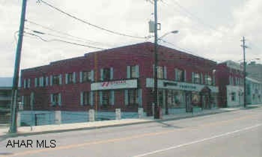 Two-Story Brick Commercial/Multi Family Building located in Bedford. Brick exterior with showcase windows, main level showroom, second level has six apartments. Income and expense available.