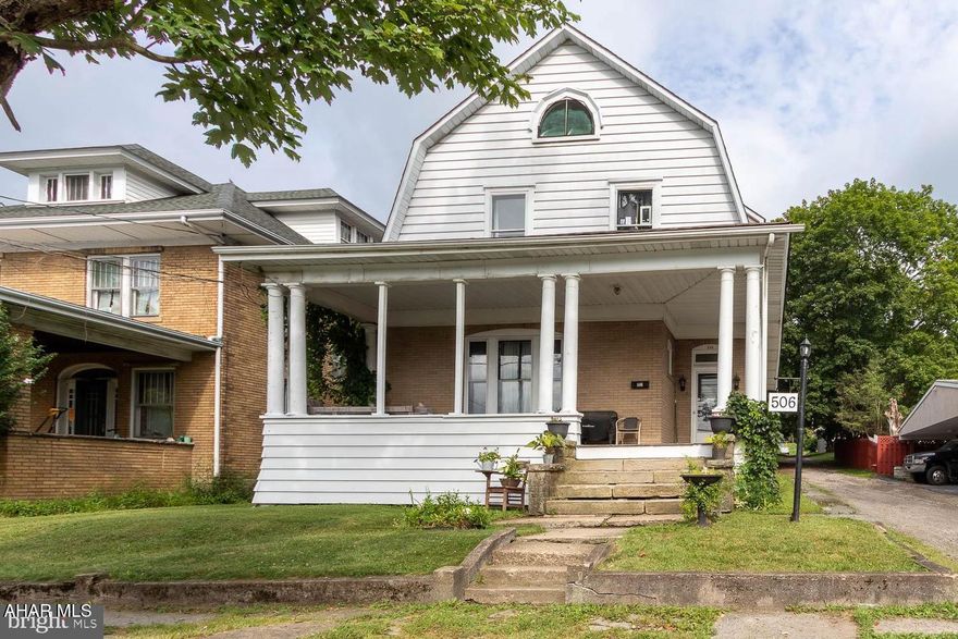 Welcome to a home that truly feels like *home* rich with personality, soul, and beautiful original woodwork that wraps every room in warmth and timeless charm. Perfectly positioned on the annual 4th of July parade route, this spacious 4-bedroom, 1.5-bath home offers not just a place to live, but a front-row seat to tradition and community. From the moment you step onto the inviting front porch, you'll sense the history and character woven into every detail. Inside, gorgeous wood trim, classic built-ins, and antique chandeliers create an atmosphere you simply don't find in newer homes. The main level offers wonderful flow with two generous living/dining areas, ideal for gathering and celebrating life's everyday moments. One of the rooms features a charming electric fireplace framed by stone, creating a cozy spot you'll love year-round. The eat-in kitchen provides plenty of room for casual meals, along with easy access to a convenient half bath and first-floor laundry. Just beyond, the backyard patio awaits summer evenings spent relaxing under the stars. Upstairs, four spacious rooms give you flexibility, bedrooms, office space, hobby rooms, or more. A quaint reading nook tucked into one of the bedrooms offers a quiet hideaway for morning coffee or a good book. A full bath completes the second floor. Venture to the attic to discover two large additional rooms brimming with potential, ready to be finished into extra bedroom space, a playroom, studio, or bonus storage. Outside, the fenced yard is perfect for pets, play, or gardening, and the two-car garage adds everyday convenience. Overflowing with character, craftsmanship, and warmth, this is the kind of home that simply *feels right* where memories are made and stories continue to grow.