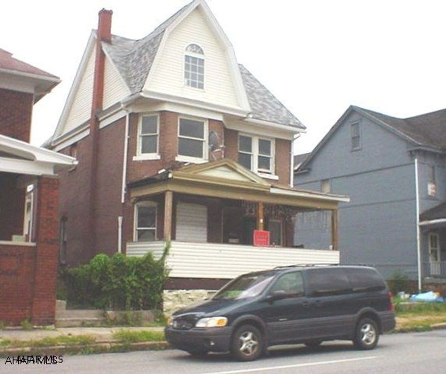 Huge Brick home with double lot and off street parking.  Needs some repair. Very nice level lot and extra sunroom makes for lots of potential.  Property to be Sold AS IS.