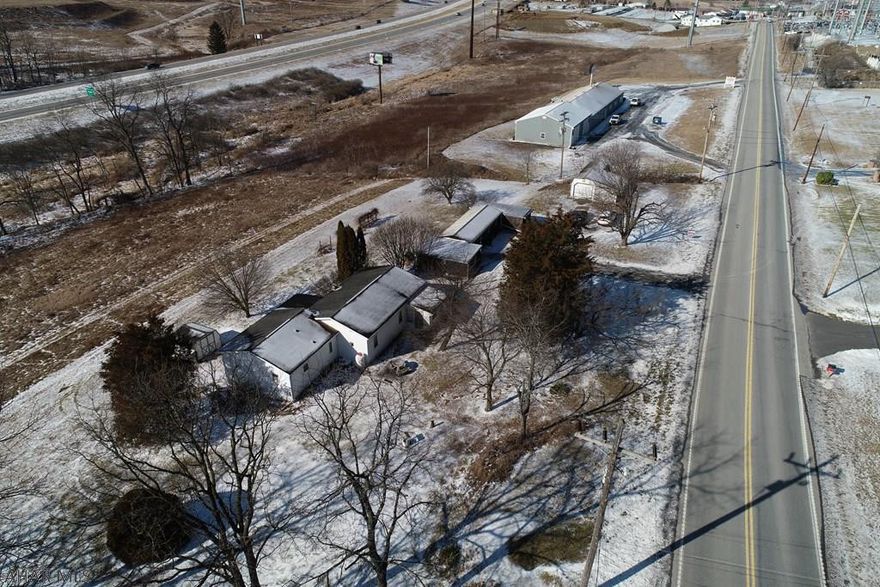 Location is what makes this property so special as it has excellent visibility from both I99 and Business 220.  This property consists of 5.0 acres and lays mainly flat.  The home was originally a single wide and does have an official title certificate.  Many rooms were built around the single wide and was used as a residential home.  It also has an additional outbuilding that was used as Bobe Ceramics and Lawn Ornament Shop.  The location lends itself to an amazing commercial business opportunity and is priced to sell.