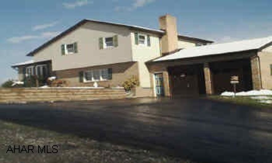 4 level split brick and vinyl with attached garage, shed, swimming pool and cabana, 40x70 oversized garage. Well kept home with extra garages on 4+ acres.  Room for workshop or storing or boats, cycles,etc.  Realtor is sister-in-law.