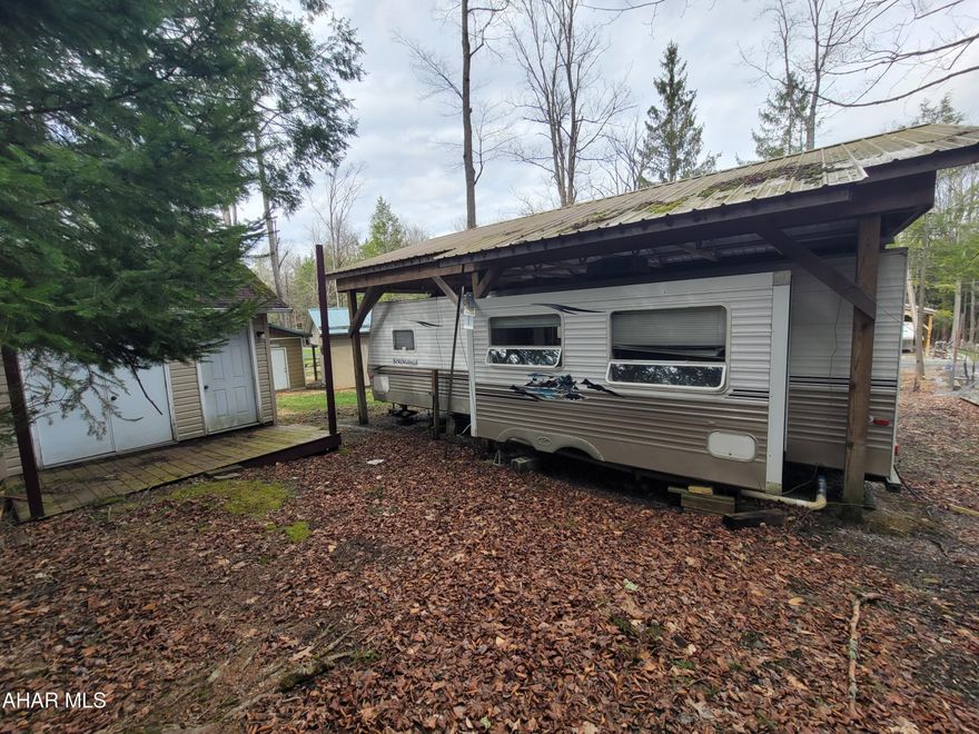 Enjoy the peace and quiet up at Glendale Year Round. This cabin is enclosed with a metal roof and an amazing porch. With all utilities available, a community pool, basketball court; this is the perfect place to relax. Enjoy the camper that has all the amenities, kitchen, living room, bathroom, and decent sized bedroom! Come tour the cabin and set up your dream vacation year after year!
