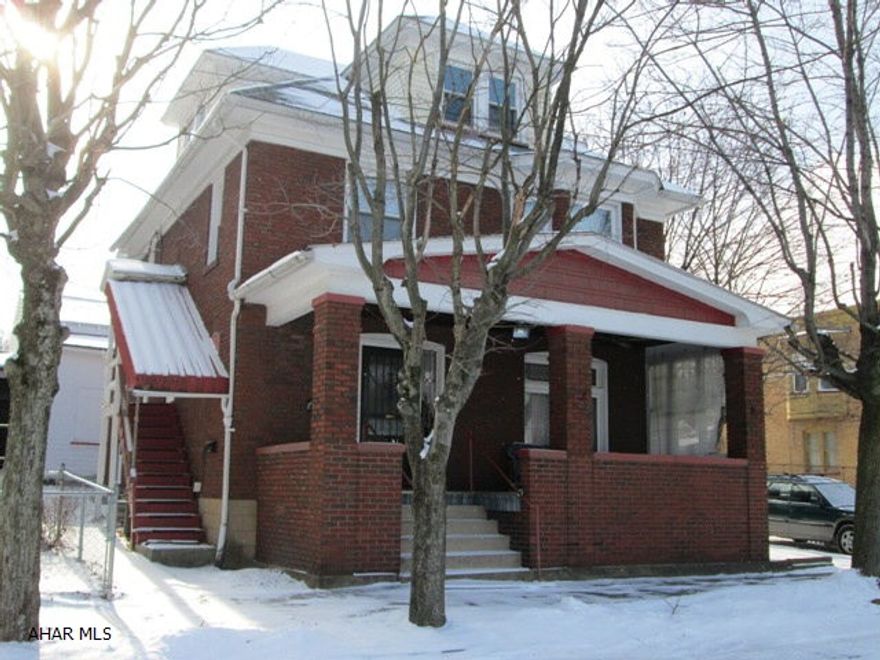 All brick duplex. Detached 4 car garage. Second floor ready to rent. The first floor  needs some TLC. Great garage storage.