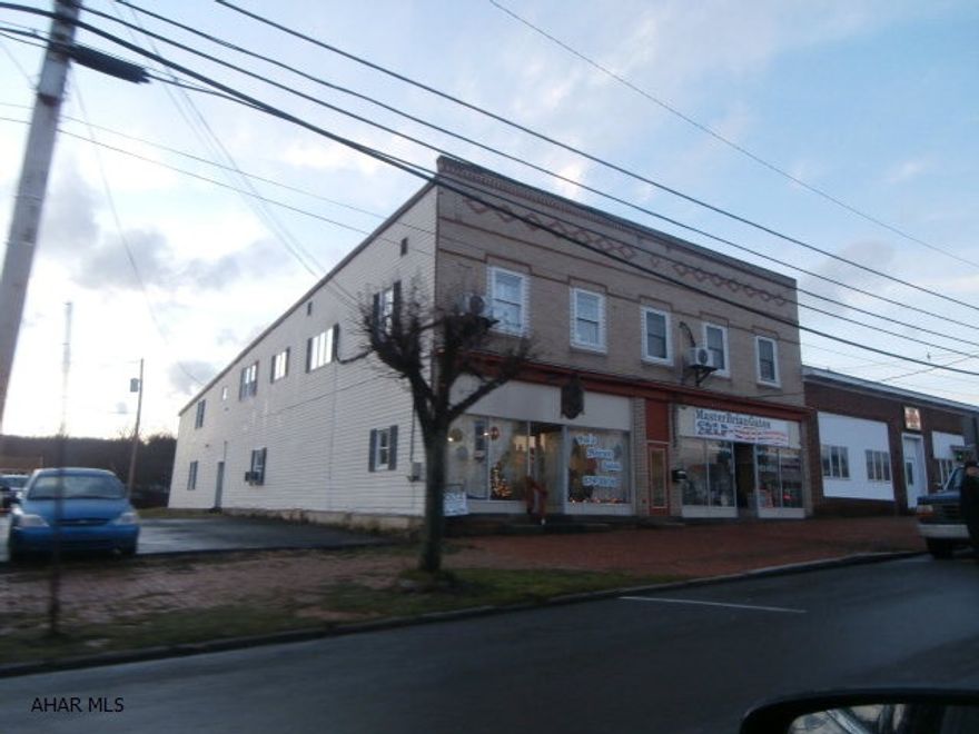 Good investment property - beats the bank!! Brick 5 unit includes 2 storefronts and garage. Separate electric, fully rented with good rental history. Second floor unit is large and was used as the owners residence. Central air - much more. Call office for details.