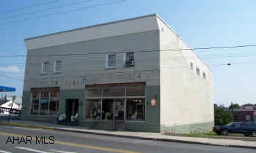 Spectacular investment opportunity.  2 storefronts plus 3 apts with great income.  Also includes adjacent vacant lot with commercial possibilities.  Limitless potential!!!    Great town center location