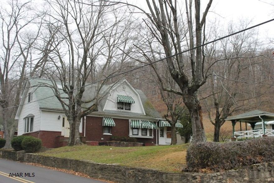 Country living close to town in Logan Township.  Spacious brick home on a large lot.  Paved U-shaped driveway provides easy access to 3 separate garages, one of which includes a heated workshop. Plenty of parking and outdoor space for all your entertaining needs. This 3 bedroom, 1 1/2 bath home has a large family room, large dining room,  and eat-in kitchen. Heated Mud room off kitchen. Property being sold AS IS, seller will make no repairs.