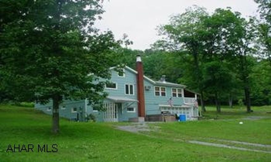 Property lines are pretty well marked.  Seller does not have survey - would be buyer's responsibility if needed. Unique property located along private lane.  Could be 3 BR with extra room on lower level. Beautiful wooded ground - good hunting or 4-wheeling!  10'-12' spring fed pond.  Natural knotty pine sunroom with woodburner.  Oak kitchen with breakfast bar.  Hardwood floors.  Finished lower level.  Storage barn and shed.